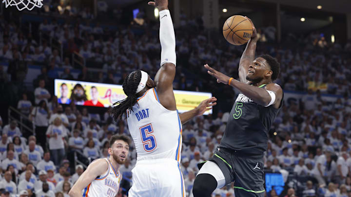 May 20, 2025; Oklahoma City, Oklahoma, USA; Minnesota Timberwolves guard Anthony Edwards (5) drives against Oklahoma City Thunder guard Luguentz Dort (5) in the second quarter during game one of the western conference finals for the 2025 NBA Playoffs at Paycom Center.