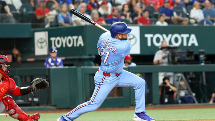 Jun 1, 2025; Arlington, Texas, USA; Texas Rangers designated hitter Jake Burger (21) hits an rbi double during the eighth inning against the St. Louis Cardinals at Globe Life Field. Mandatory Credit: Kevin Jairaj-Imagn Images