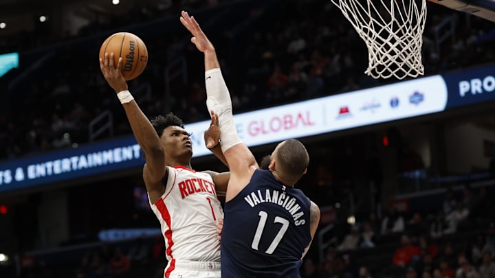 Jan 7, 2025; Washington, District of Columbia, USA; Houston Rockets forward Amen Thompson (1) shoots the ball as Washington Wizards center Jonas Valanciunas (17) defends in the third quarter at Capital One Arena. Mandatory Credit: Geoff Burke-Imagn Images