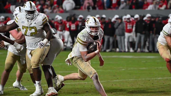 Nov 1, 2025; Raleigh, North Carolina, USA;  Georgia Tech Yellow Jackets quarterback Haynes King (10) scores a touchdown during the fourth quarter against the NC State Wolfpack at Carter-Finley Stadium. Mandatory Credit: Zachary Taft-Imagn Images