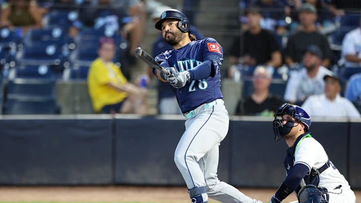 Sep 1, 2025; Tampa, Florida, USA; Seattle Mariners third baseman Eugenio Suarez (28) doubles against the Tampa Bay Rays in the second inning at George M. Steinbrenner Field. Mandatory Credit: Nathan Ray Seebeck-Imagn Images