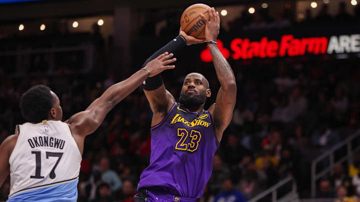 Dec 6, 2024; Atlanta, Georgia, USA; Los Angeles Lakers forward LeBron James (23) shoots over Atlanta Hawks forward Onyeka Okongwu (17) in the second quarter at State Farm Arena. Mandatory Credit: Brett Davis-Imagn Images