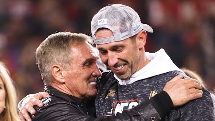 Jan 19, 2020; Santa Clara, California, USA; San Francisco 49ers head coach Kyle Shanahan celebrates the 37-20 victory against the Green Bay Packers  with his father Mike Shanahan in the NFC Championship Game at Levi's Stadium. Mandatory Credit: Kelley L Cox-Imagn Images