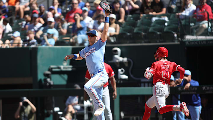 Sep 8, 2024; Arlington, Texas, USA; Texas Rangers first base Nathaniel Lowe (30) makes the put out at first base against Los Angeles Angels shortstop Zach Neto (9) in the sixth inning at Globe Life Field. Mandatory Credit: Tim Heitman-Imagn Images
