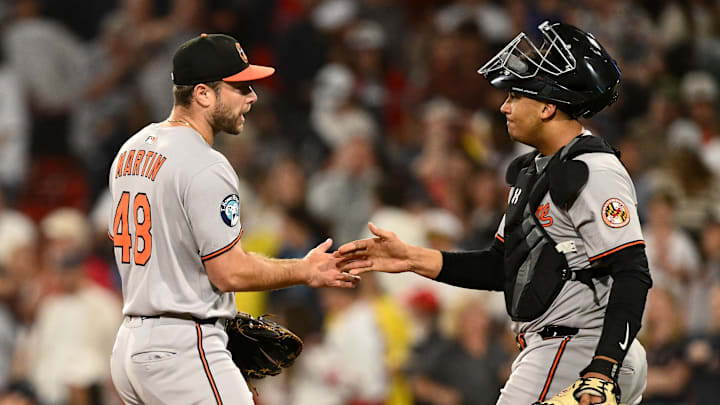 Aug 19, 2025; Boston, Massachusetts, USA; Baltimore Orioles relief pitcher Corbin Martin (48) high-fives catcher Alex Jackson (70) after a game against the Boston Red Sox at Fenway Park. Mandatory Credit: Brian Fluharty-Imagn Images