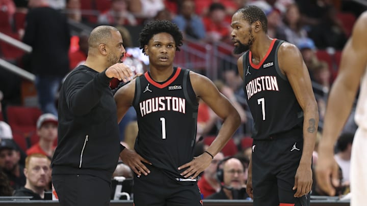 Dec 27, 2025; Houston, Texas, USA;  Houston Rockets head coach Ime Udoka talks with guard Amen Thompson (1) and forward Kevin Durant (7) during the third quarter against the Cleveland Cavaliers at Toyota Center. Mandatory Credit: Troy Taormina-Imagn Images