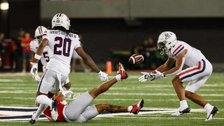 Aug 31, 2024; Tucson, Arizona, USA; Arizona Wildcats defensive back Treydan Stukes (2) intercepts ball from New Mexico Lobos wide receiver Shawn Miller (14) during third quarter at Arizona Stadium. Mandatory Credit: Aryanna Frank-Imagn Images