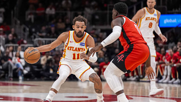 Oct 16, 2025; Atlanta, Georgia, USA; Atlanta Hawks point guard Trae Young (11) dribbles against Houston Rockets guard Aaron Holiday (0) during the first half at State Farm Arena. Mandatory Credit: Dale Zanine-Imagn Images
