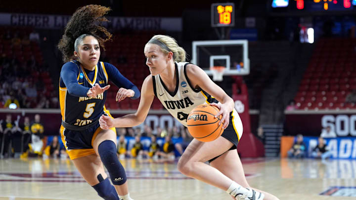 Iowa's Kylie Feuerbach (4) drives to the basket as Murray State's Trinity White (5) defends during first half of the first round of the NCAA Women's college basketball game between Iowa and Murray State at the Lloyd Noble Center in Norman, Okla., Saturday, March, 22, 2025.
