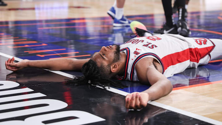 Jan 3, 2026; New York, New York, USA;  St. John's basketball forward Zuby Ejiofor (24) lies on the court after getting fouled in the second half against the Providence Friars at Madison Square Garden.