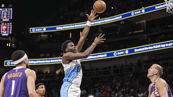 Jan 14, 2025; Atlanta, Georgia, USA; Atlanta Hawks center Clint Capela (15) shoots over Phoenix Suns center Mason Plumlee (22) during the first half at State Farm Arena. Mandatory Credit: Dale Zanine-Imagn Images