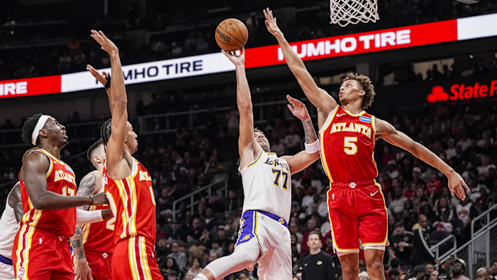 Nov 8, 2025; Atlanta, Georgia, USA; Los Angeles Lakers guard Luka Doncic (77) shoots against Atlanta Hawks guard Dyson Daniels (5)  during the first half at State Farm Arena. Mandatory Credit: Dale Zanine-Imagn Images