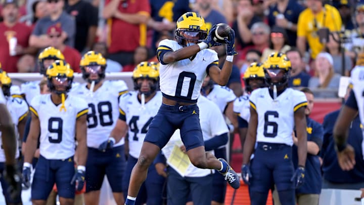 Oct 11, 2025; Los Angeles, California, USA;  Michigan Wolverines wide receiver Semaj Morgan (0) makes a catch for a first down in the first half against the USC Trojans at United Airlines Field at the Los Angeles Memorial Coliseum. Mandatory Credit: Jayne Kamin-Oncea-Imagn Images