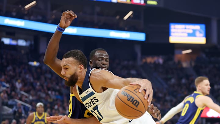 Minnesota Timberwolves' center Rudy Gobert battles against Golden State Warriors' forward Draymond Green