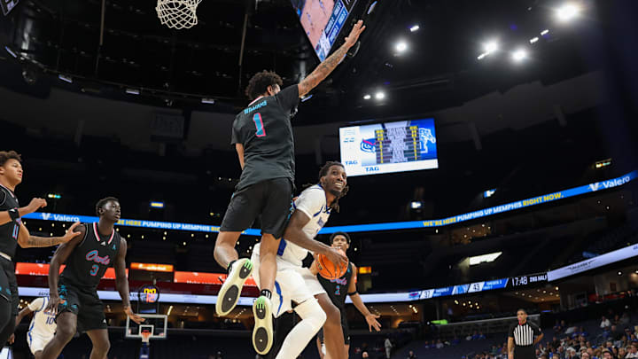 Jan 29, 2026; Memphis, Tennessee, USA; Memphis Tigers forward Aaron Bradshaw (11) handles the ball against Florida Atlantic Owls forward Devin Williams (1) during the second half at FedExForum. Mandatory Credit: Wesley Hale-Imagn Images