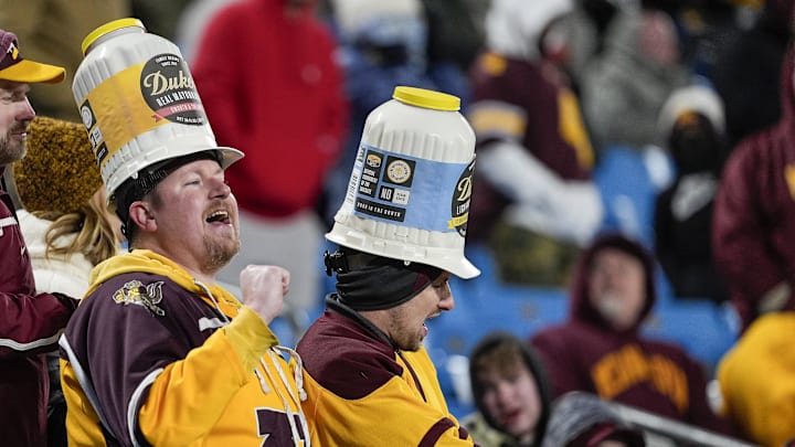 Jan 3, 2025; Charlotte, NC, USA; Minnesota Golden Gophers fans wearing their Dukes hats during the second half against the Virginia Tech Hokies at the Duke’s Mayo Bowl at Bank of America Stadium. Mandatory Credit: Jim Dedmon-Imagn Images Jan 3, 2025; Charlotte, NC, USA; Minnesota Golden Gophers fans wearing their Dukes hats during the second half against the Virginia Tech Hokies at the Duke’s Mayo Bowl at Bank of America Stadium. Mandatory Credit: Jim Dedmon-Imagn Images