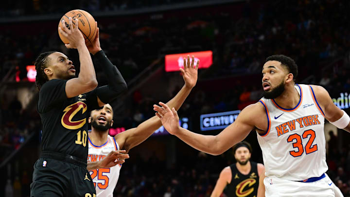Feb 21, 2025; Cleveland, Ohio, USA;  Cleveland Cavaliers guard Darius Garland (10) shoots as New York Knicks center Karl-Anthony Towns (32) defends during the second half at Rocket Arena. Mandatory Credit: Ken Blaze-Imagn Images