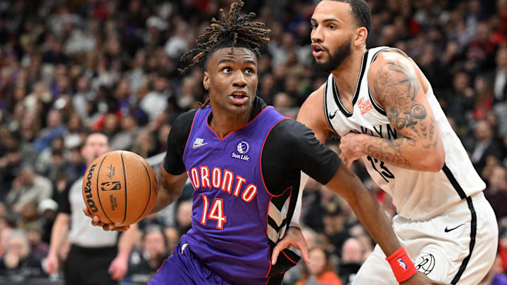 Dec 19, 2024; Toronto, Ontario, CAN;  Toronto Raptors guard Ja'Kobe Walter (14) drives to the basket past Brooklyn Nets forward Tyrese Martin (13) in the second half at Scotiabank Arena. Mandatory Credit: Dan Hamilton-Imagn Images