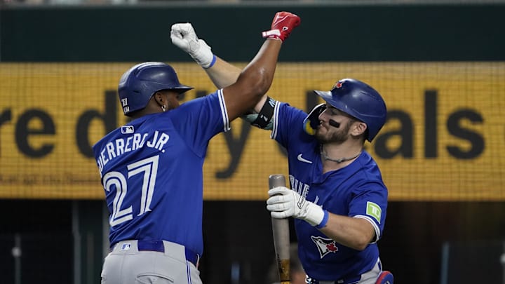 Sep 19, 2024; Arlington, Texas, USA; Toronto Blue Jays first baseman Vladimir Guerrero Jr. (27) bumps arms with second baseman Spencer Horwitz (48) after hitting a solo home run during the seventh inning at Globe Life Field. Mandatory Credit: Raymond Carlin III-Imagn Images