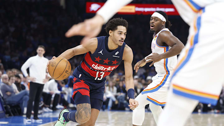 Dec 23, 2024; Oklahoma City, Oklahoma, USA; Washington Wizards guard Jordan Poole (13) moves past Oklahoma City Thunder guard Luguentz Dort (5) during the second quarter at Paycom Center. Mandatory Credit: Alonzo Adams-Imagn Images