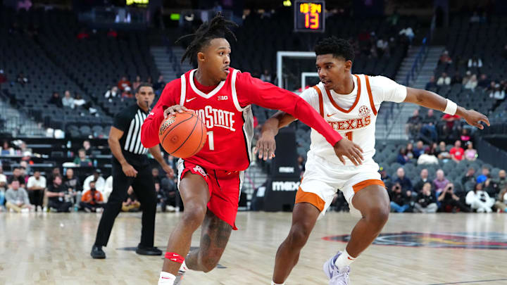Nov 4, 2024; Las Vegas, Nevada, USA; Ohio State Buckeyes guard Meechie Johnson Jr. (1) dribbles against Texas Longhorns guard Julian Larry (1) during the second half at T-Mobile Arena. Mandatory Credit: Stephen R. Sylvanie-Imagn Images