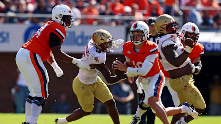 Oct 5, 2024; Charlottesville, Virginia, USA; Virginia Cavaliers quarterback Anthony Colandrea (10) runs the ball against Boston College Eagles defensive end Donovan Ezeiruaku (6) during the second quarter at Scott Stadium. Mandatory Credit: Peter Casey-Imagn Images