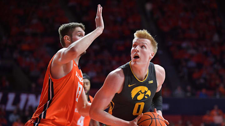Feb 25, 2025; Champaign, Illinois, USA;  Illinois Fighting Illini center Tomislav Ivisic (13) guards Iowa Hawkeyes forward Even Brauns (0) during the second half at State Farm Center. Mandatory Credit: Ron Johnson-Imagn Images