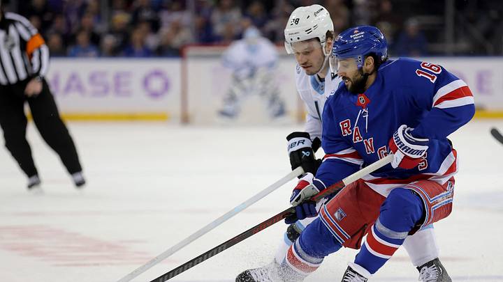 Jan 5, 2026; New York, New York, USA; New York Rangers center Vincent Trocheck (16) fights for the puck against Utah Mammoth defenseman Mikhail Sergachev (98) during the first period at Madison Square Garden. Mandatory Credit: Brad Penner-Imagn Images