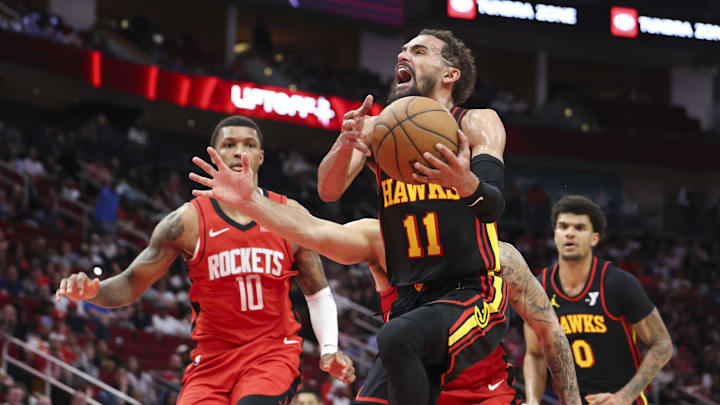 Mar 25, 2025; Houston, Texas, USA; Atlanta Hawks guard Trae Young (11) drives with the ball during the third quarter against the Houston Rockets at Toyota Center. Mandatory Credit: Troy Taormina-Imagn Images