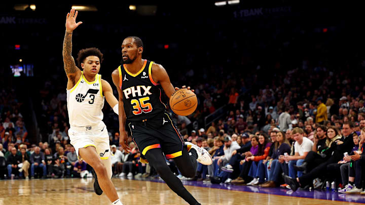 Feb 8, 2024; Phoenix, Arizona, USA; Phoenix Suns forward Kevin Durant (35) drives to the basket against Utah Jazz guard Keyonte George (3) during the third quarter at Footprint Center. Mandatory Credit: Mark J. Rebilas-Imagn Images