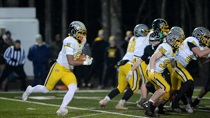 Cameron Clem carries the ball in the game at Mountain heritage, December 6, 2024.