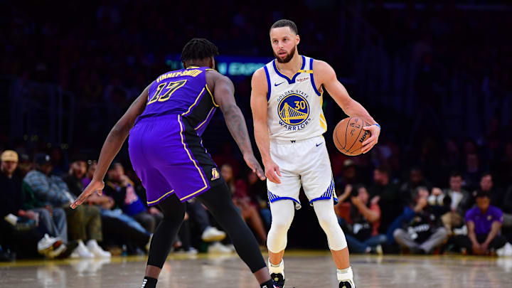 Feb 6, 2025; Los Angeles, California, USA; Golden State Warriors guard Stephen Curry (30) controls the ball against Los Angeles Lakers forward Dorian Finney-Smith (17) during the second half at Crypto.com Arena. Mandatory Credit: Gary A. Vasquez-Imagn Images