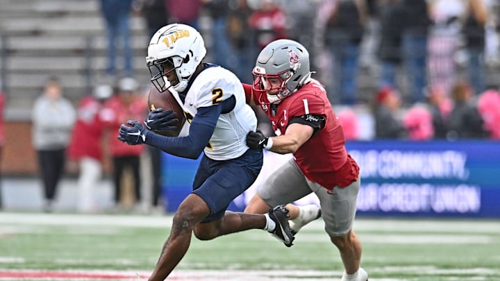 Oct 25, 2025; Pullman, Washington, USA; Toledo Rockets wide receiver Junior Vandeross III (2) makes a catch against Washington State Cougars safety Tucker Large (1) in the second half at Gesa Field at Martin Stadium. Mandatory Credit: James Snook-Imagn Images