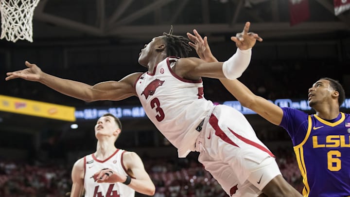 Feb 12, 2025; Fayetteville, Arkansas, USA;  Arkansas Razorbacks forward Adou Thiero (3) puts up an underhanded shot past LSU Tigers forward Robert Miller III (6) during the second half at Bud Walton Arena. Arkansas won 70-58. Mandatory Credit: Brett Rojo-Imagn Images