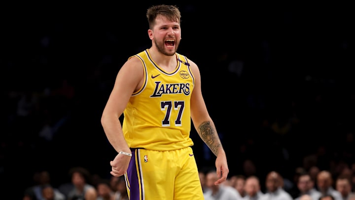 Mar 10, 2025; Brooklyn, New York, USA; Los Angeles Lakers guard Luka Doncic (77) reacts after a three point shot against the Brooklyn Nets during the second quarter at Barclays Center. Mandatory Credit: Brad Penner-Imagn Images