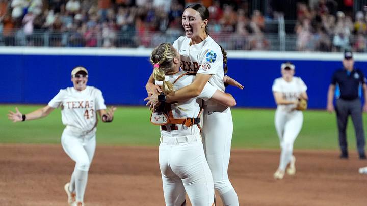 Texas's Teagan Kavan (17) and Shylien Brister (11) celebrate following the Women's College World Series.