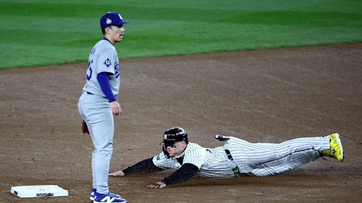 Oct 30, 2024; New York, New York, USA; New York Yankees outfielder Alex Verdugo (24) advances to second on a wild pitch in front of Los Angeles Dodgers outfielder Tommy Edman (25) during the second inning in game five of the 2024 MLB World Series at Yankee Stadium. Mandatory Credit: Wendell Cruz-Imagn Images
