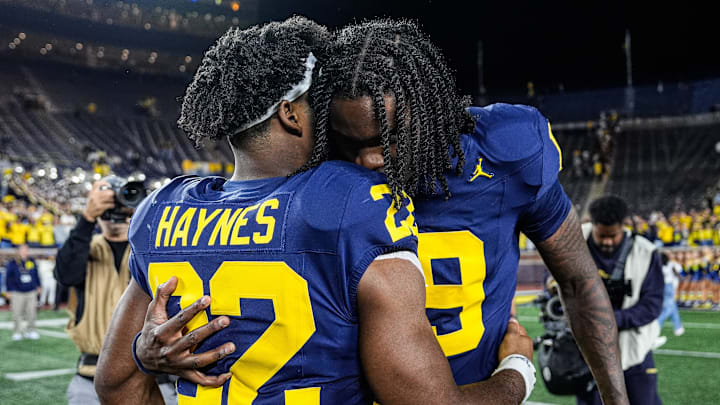 Michigan quarterback Bryce Underwood (19) hugs running back Justice Haynes (22) on the field after 34-17 win at Michigan Stadium in Ann Arbor on Saturday, August 30, 2025.
