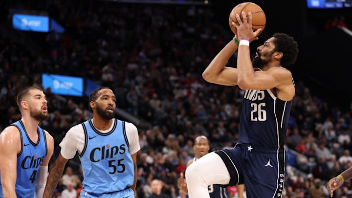 Apr 5, 2025; Inglewood, California, USA;  Dallas Mavericks guard Spencer Dinwiddie (26) shoots the ball against Los Angeles Clippers center Ivica Zubac (40) and forward Derrick Jones Jr. (55) during the third quarter at Intuit Dome. Mandatory Credit: Kiyoshi Mio-Imagn Images