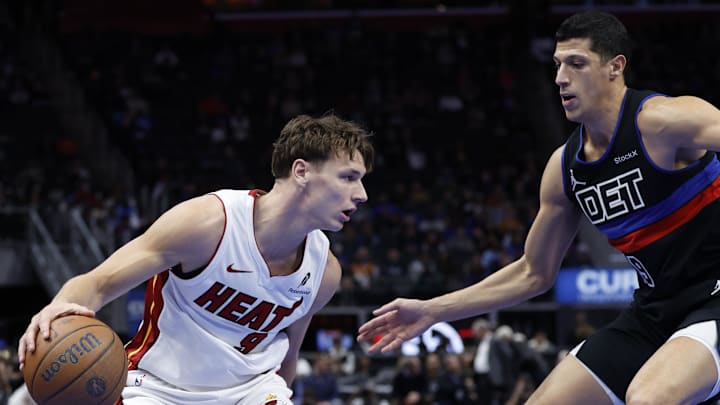 Nov 12, 2024; Detroit, Michigan, USA;  Miami Heat guard Pelle Larsson (9) dribbles defended by Detroit Pistons forward Simone Fontecchio (19) in the first half at Little Caesars Arena. Mandatory Credit: Rick Osentoski-Imagn Images