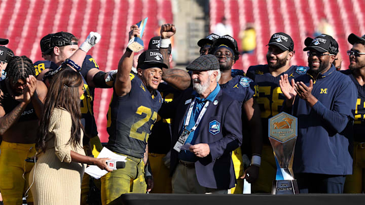 Dec 31, 2024; Tampa, FL, USA;  Michigan Wolverines running back Jordan Marshall (23) is given the MVP award after beating the Alabama Crimson Tide in the ReliaQuest Bowl at Raymond James Stadium. Mandatory Credit: Nathan Ray Seebeck-Imagn Images
