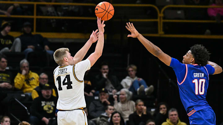 Dec 29, 2025; Iowa City, Iowa, USA; Iowa Hawkeyes guard Bennett Stirtz (14) shoots a three point basket as UMass Lowell River Hawks forward Austin Green (10) defends during the first half at Carver-Hawkeye Arena. Mandatory Credit: Jeffrey Becker-Imagn Images Dec 29, 2025; Iowa City, Iowa, USA; Iowa Hawkeyes guard Bennett Stirtz (14) shoots a three point basket as UMass Lowell River Hawks forward Austin Green (10) defends during the first half at Carver-Hawkeye Arena. Mandatory Credit: Jeffrey Becker-Imagn Images