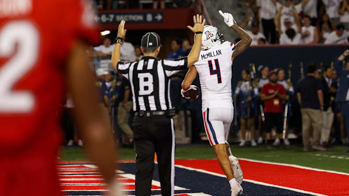 Aug 31, 2024; Tucson, Arizona, USA; Arizona Wildcats wide receiver Tetairoa McMillan (4) celebrates touchdown while Game Official back judge Donnie Aultman confirms touchdown during second quarter at Arizona Stadium. Mandatory Credit: Aryanna Frank-Imagn Images