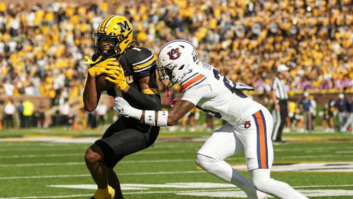 Oct 19, 2024; Columbia, Missouri, USA; Missouri Tigers wide receiver Theo Wease Jr. (1) runs with the ball against Auburn Tigers cornerback Jay Crawford (23) during the second half at Faurot Field at Memorial Stadium. Mandatory Credit: Jay Biggerstaff-Imagn Images