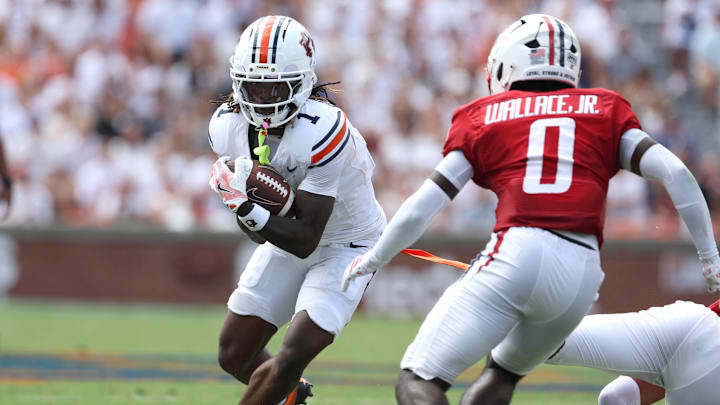 Sep 13, 2025; Auburn, Alabama, USA; South Alabama Jaguars safety Christopher Wallace Jr. (0) closes in on Auburn Tigers wide receiver Eric Singleton Jr. (1) during the second quarter at Jordan-Hare Stadium. Mandatory Credit: John Reed-Imagn Images