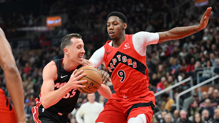 Dec 1, 2024; Toronto, Ontario, CAN;  Miami Heat forward Duncan Robinson (55) drives to the basket as Toronto Raptors forward RJ Barrett (9) defends in the first half at Scotiabank Arena. Mandatory Credit: Dan Hamilton-Imagn Images
