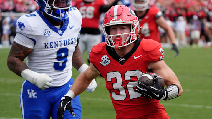 Georgia running back Cash Jones (32) drives in to score a touchdown during the second half of a NCAA college football game against Kentucky in Athens, Ga., on Saturday, October 4, 2025.