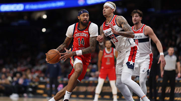 Dec 13, 2023; Washington, District of Columbia, USA; New Orleans Pelicans forward Brandon Ingram (14) drives to the basket as Washington Wizards forward Kyle Kuzma (33) defends in the third quarter at Capital One Arena. Mandatory Credit: Geoff Burke-Imagn Images