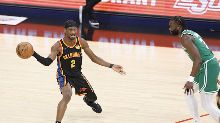 Jan 5, 2025; Oklahoma City, Oklahoma, USA; Oklahoma City Thunder guard Shai Gilgeous-Alexander (2) passes the ball while defended by Boston Celtics guard Jaylen Brown (7) during the first quarter at Paycom Center. Mandatory Credit: Alonzo Adams-Imagn Images Jan 5, 2025; Oklahoma City, Oklahoma, USA; Oklahoma City Thunder guard Shai Gilgeous-Alexander (2) passes the ball while defended by Boston Celtics guard Jaylen Brown (7) during the first quarter at Paycom Center. Mandatory Credit: Alonzo Adams-Imagn Images