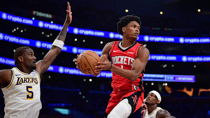 Dec 25, 2025; Los Angeles, California, USA; Houston Rockets guard Amen Thompson (1) passes the ball against the defense of Los Angeles Lakers center Deandre Ayton (5) during the second half at Crypto.com Arena. Mandatory Credit: Gary A. Vasquez-Imagn Images